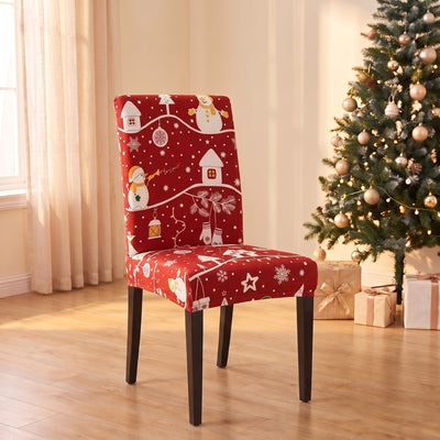 Snowman Village Christmas stretch chair cover on a dining chair by the Christmas tree