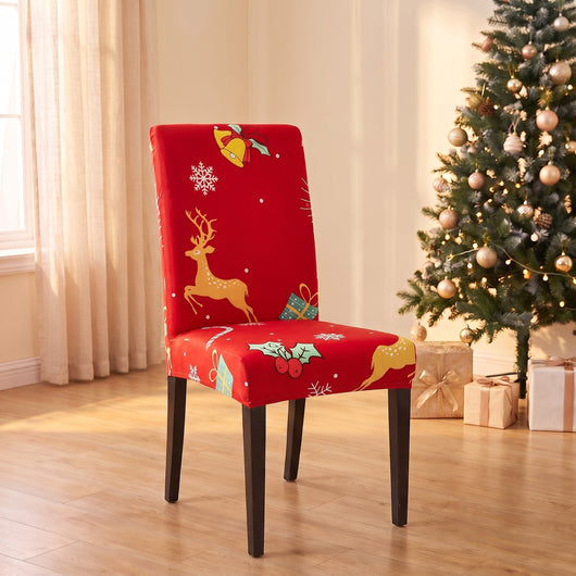 Jingle Reindeer Christmas stretch chair cover on a dining chair by the Christmas tree