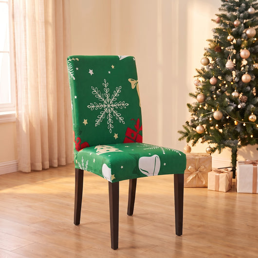 Green Snowflake Christmas stretch chair cover on a dining chair by the Christmas tree