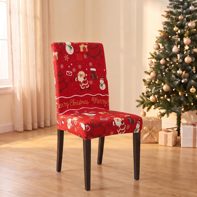 Merry Gingerbread Christmas stretch chair cover on a dining chair by the Christmas tree