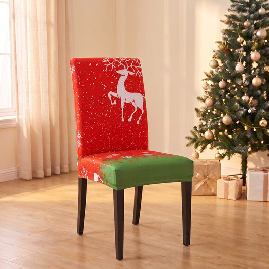 Red & Green Reindeer Christmas stretch chair cover on a dining chair by the Christmas tree