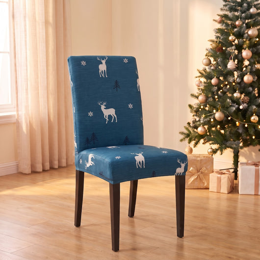 Blue Reindeer Christmas stretch chair cover on a dining chair by the Christmas tree