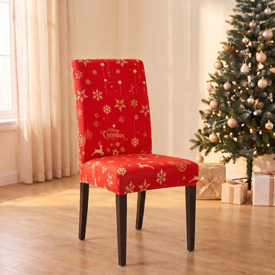 Red Snowflake Christmas stretch chair cover on a dining chair by the Christmas tree