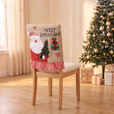 Linen Santa Christmas chair back cover on a dining chair by the Christmas tree