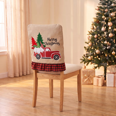 Red Truck Christmas chair back cover on a dining chair by the Christmas tree
