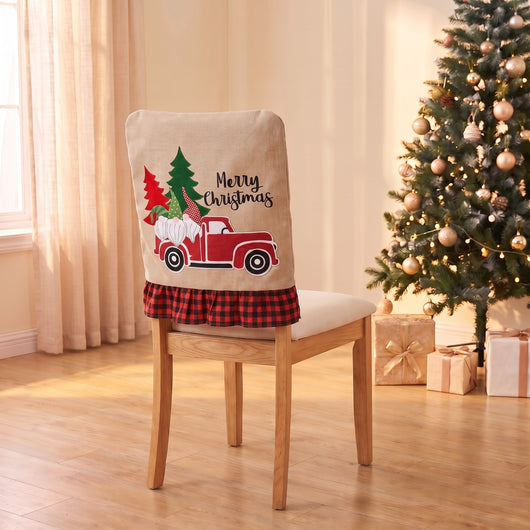 Red Truck Christmas chair back cover on a dining chair by the Christmas tree