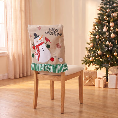 Linen Snowman Christmas chair back cover on a dining chair by the Christmas tree