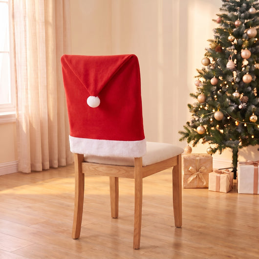 Classic Santa Hat Christmas chair back cover on a dining chair by the Christmas tree