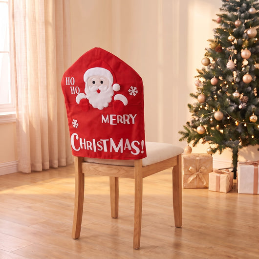 Ho Ho Santa Christmas chair back cover on a dining chair by the Christmas tree